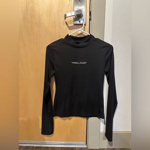 Black mock neck “Feelings” tshirt.